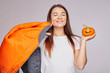 © Yulia - Positive mixed race female in white t-shirt, trendy bomber, holds autumn smiling pumpkin,closing eyes from pleasure, being in high spirit, celebrates Halloween in October, happy to have good harvest.