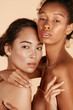 © puhhha - Beauty. Multi-ethnic women with natural face makeup and healthy skin portrait. Different ethnicity girls, beautiful asian and african models with glowing skin on beige background. Spa skin care