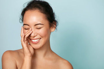 Wall Mural - beauty face. smiling asian woman touching healthy skin portrait. beautiful happy girl model with fre
