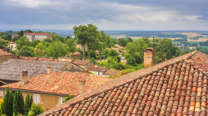 Summer city landscape - view of the roofs of houses in a provincial French town, in the historical province Gascony, the region of Occitanie of southwestern France