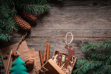 Wall Mural - Christmas green frame from fir branches on a vintage gray board background. Frame of fir branches. Christmas card blank.