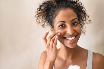 Wall Mural - Beautiful girl applying face cream