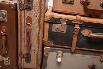 Wall Mural - Old, retro, suitcases lie on the table with white background