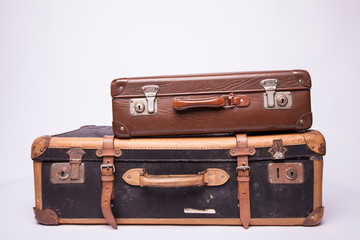 Wall Mural - Old, retro, suitcases lie on the table with white background