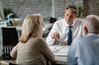 © Drazen - Financial advisor having a meeting with senior couple in the office.