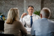 © Drazen - Happy insurance agent having consultations with senior couple in the office.