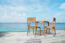 Outdoor Terrace With Empty  Wooden Table And Chair With Sea View Of Indain Ocean, Maldives Background