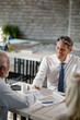 © Drazen - Happy insurance agent shaking hands with senior client in the office.