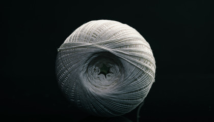 Poster - Beautiful white tangle of thread on a dark  background texture.