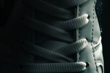 Beautiful white shoeloces  on a dark background texture.