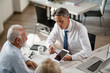 © Drazen - Financial advisor using touchpad while having consultations with senior clients in the office.