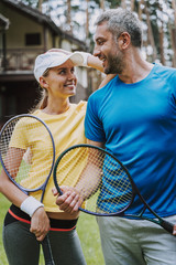 Wall Mural - Beautiful couple with tennis rackets enjoying day