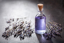 Glass Bottle Of Lavender Essential Oil With Dried Lavender Flowers