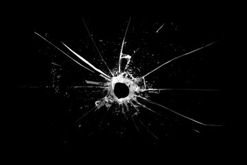 Poster - hole in the glass with cracks isolated on a black background