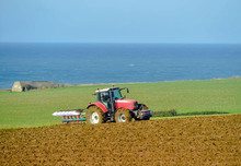 Farmer Plowing His Fields In Autumn