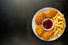 Fried Chicken With French Fries And Food Nuggets - On Stone Background