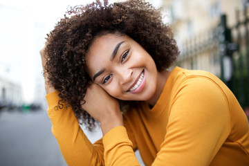 Wall Mural - close up beautiful young african american woman smiling with curly hair