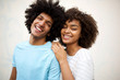 laughing afro man and smiling african american woman against white background