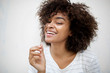 © mimagephotos - beautiful smiling young african american woman pulling hair