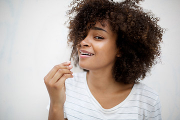 Wall Mural - smiling young african american woman pulling hair