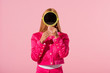 trendy african american woman hiding face behind mirror isolated on pink, fashion doll concept