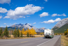 An RV Aon The Highway Through The Canadian Rocky Mountains In Kananaskis, Alberta, Canada During The Peak Of Autumn Colors