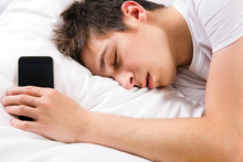 Young Man Sleep With A Phone