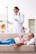 © Elnur - Young male doctor visiting old patient at home