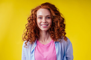 good mood concept. happy snow white smile redhead ginger woman feeling endorphins and love posing in studio over yellow background