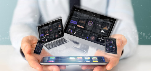 Poster - Businessman holding Devices connected to a cloud multimedia network 3d rendering