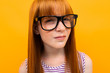 © Ivan Traimak - red-haired girl with poor eyesight on a yellow background