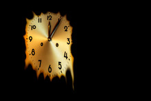 Mechanical Clock Face That Melts At Five Minutes Past Midnight Time On A Black Background Copy Space