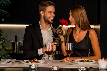 Wall Mural - Young man and woman having romantic dinner