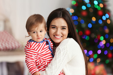 Wall Mural - Mother and her cute baby at home. Christmas celebration