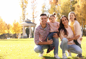 Wall Mural - Happy family with little daughters in park. Autumn walk