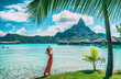 Bora Bora Tahiti vacation woman at luxury hotel in French Polynesia, tourist enjoying tropical summer resort lifestyle.