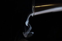 Smoke Flows From A Glass Abstract Black Background
