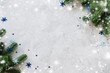 Christmas of New Year background with fir branches and blue baubles on a gray concrete.