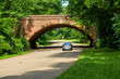 Colonial Parkway - A sunny Spring morning view of winding and scenic Colonial Parkway at one of its many brick bridges in Colonial National Historical Park, near Williamsburg, Virginia, USA.