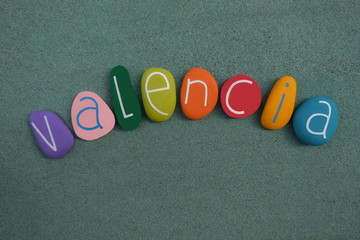 Valencia, Spain, souvenir with a multicolored stones composition over green sand