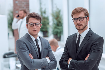 two happy business partners standing in the office