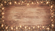 frame of lights bokeh flares and sparkler isolated on rustic brown wooden wood table texture - holiday New Year's Eve Sylvester new year 2024 background banner  