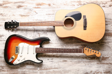 Modern guitars on wooden background