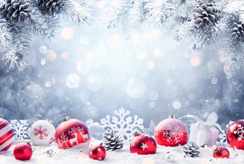 Wall Mural - christmas - red ornament on snow with fir branches