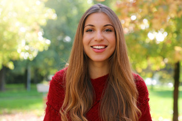 Close up of smiling cheerful woman at the park.