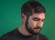 © Nailotl - Latin guy with beard on a green background