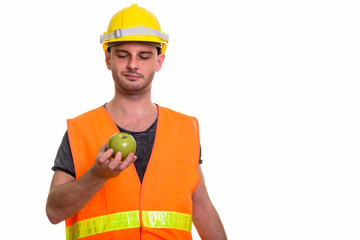 studio shot of young man construction worker holding and looking