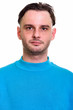 © Ranta Images - Face of man wearing blue sweater looking at camera