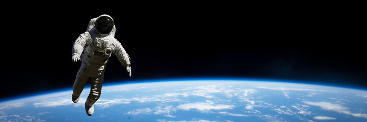 Wall Mural - astronaut performing a spacewalk in empty space