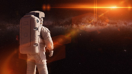Wall Mural - standing astronaut looking into empty space
